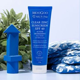 MooGoo Skincare Clear Zinc Sunscreen SPF 40 120g with child playing blocks.