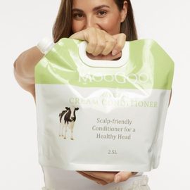 Girl holding refill Cream Conditioner 2.5L pouch